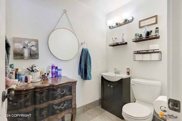 bathroom with tile patterned floors, vanity, and toilet