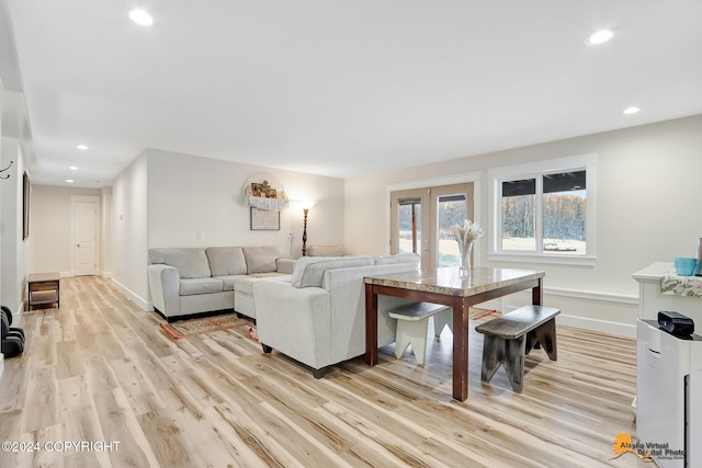 living room featuring french doors and light hardwood / wood-style floors