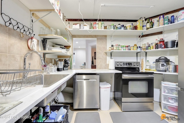 kitchen featuring sink, tile walls, and appliances with stainless steel finishes