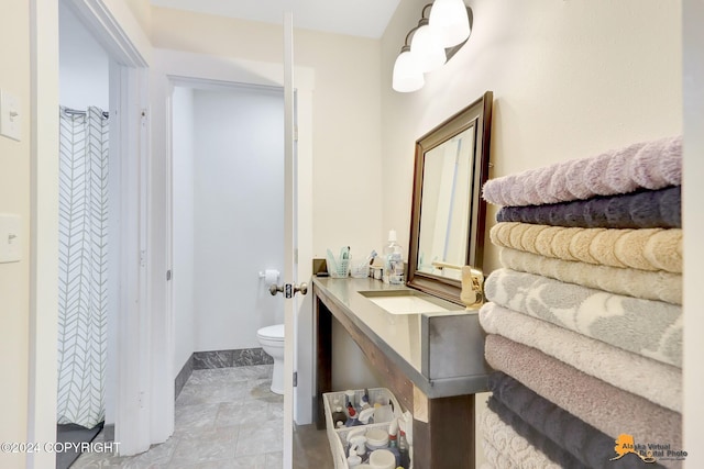 bathroom with tile patterned floors, vanity, and toilet