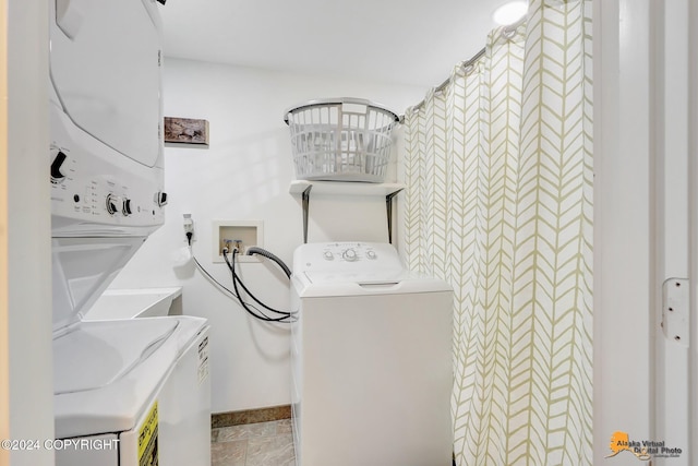 laundry area featuring stacked washer and clothes dryer