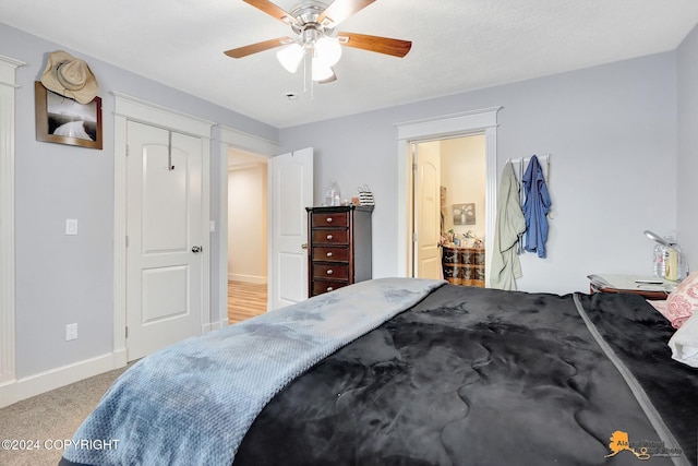 carpeted bedroom featuring a closet and ceiling fan