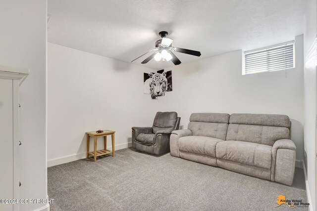 carpeted living room featuring ceiling fan