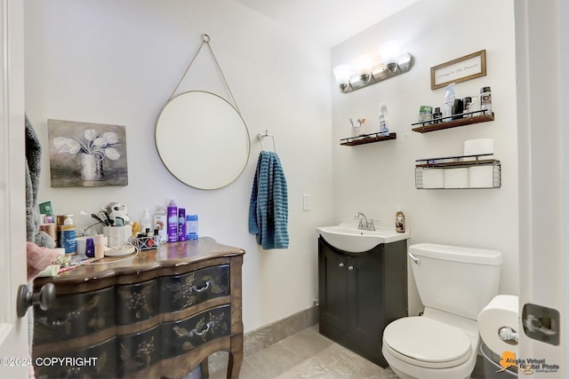 bathroom with tile patterned floors, vanity, and toilet