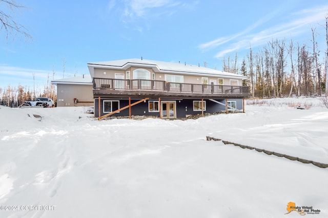 snow covered property featuring a wooden deck