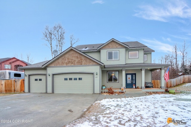 view of front of property with covered porch and a garage