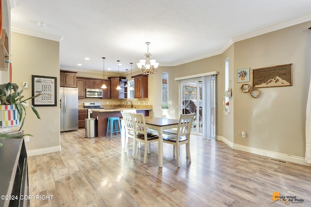 dining space with a chandelier, light wood-type flooring, crown molding, and sink