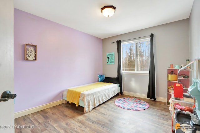 bedroom with hardwood / wood-style flooring