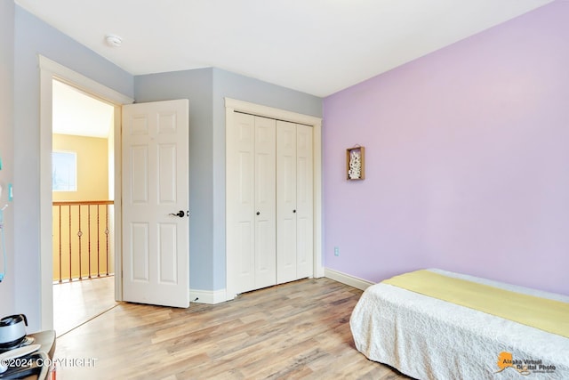 bedroom featuring light hardwood / wood-style floors and a closet