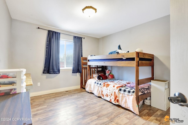 bedroom with wood-type flooring