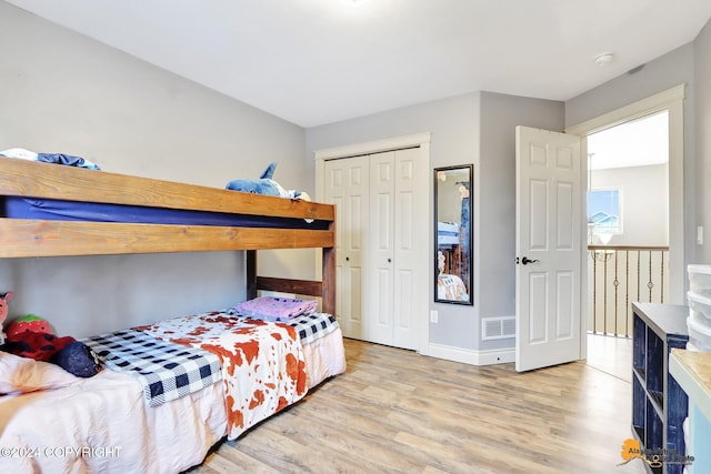 bedroom featuring light wood-type flooring and a closet