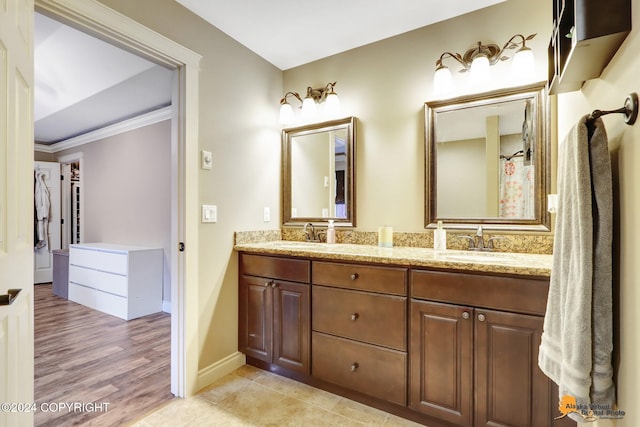 bathroom with hardwood / wood-style floors, vanity, and crown molding