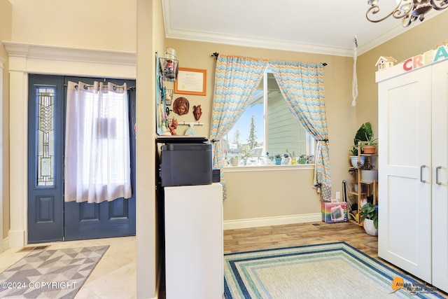 entrance foyer featuring light wood-type flooring and ornamental molding