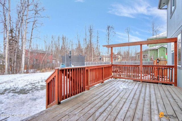 snow covered deck with a trampoline