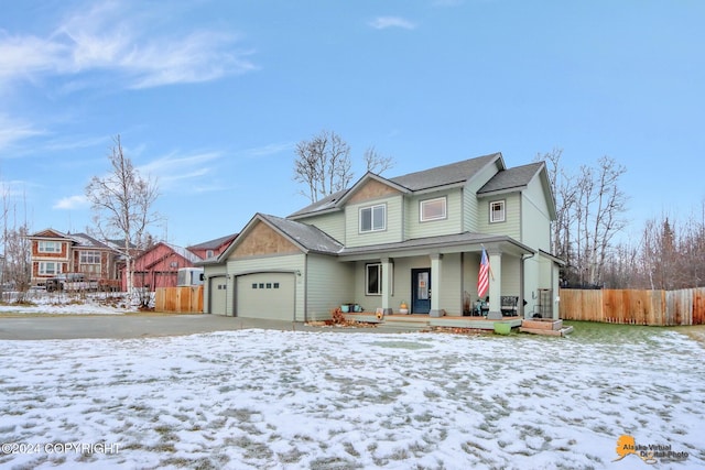 view of front of house featuring covered porch and a garage