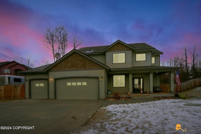 view of front of property featuring covered porch and a garage