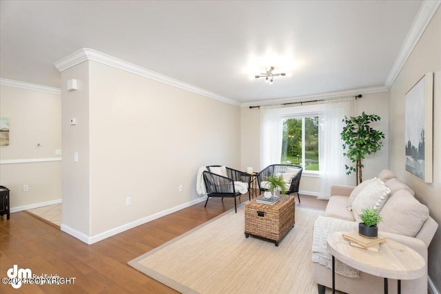 living area with hardwood / wood-style floors and crown molding