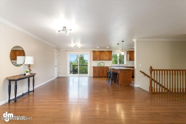 living room featuring ornamental molding and dark hardwood / wood-style flooring