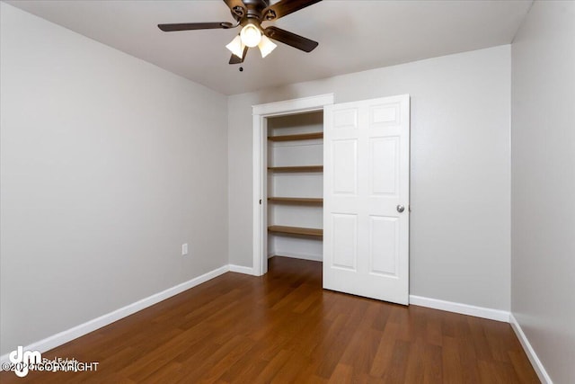 unfurnished bedroom featuring dark wood-type flooring and ceiling fan