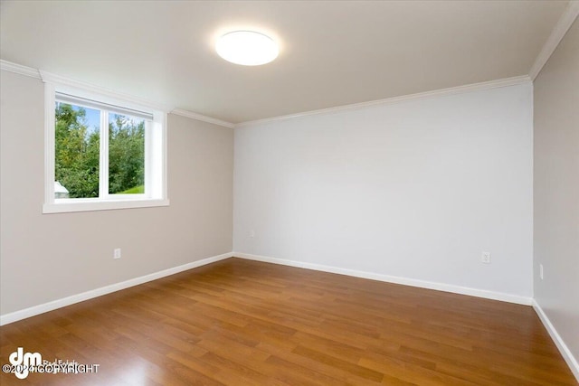 unfurnished room with wood-type flooring and crown molding