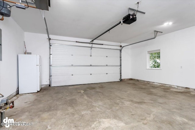 garage featuring a garage door opener and white fridge