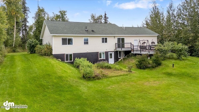 back of house with a yard and a deck