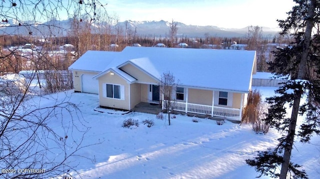 ranch-style home with a mountain view and a garage