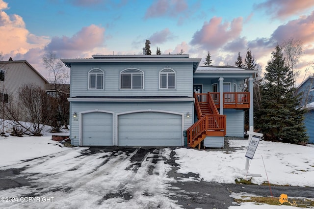 view of front of property featuring a porch and a garage