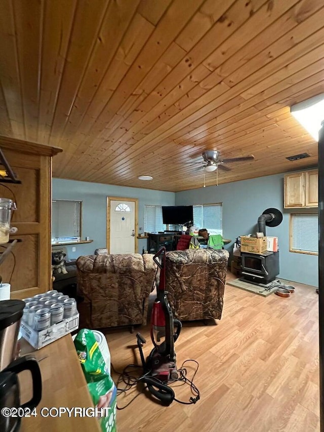 living room featuring wood-type flooring, ceiling fan, and wood ceiling