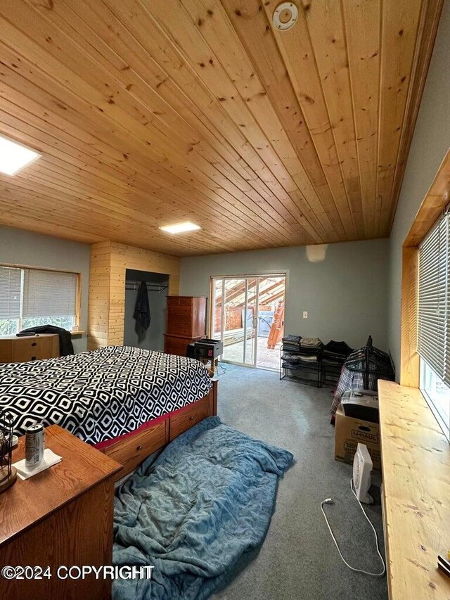 bedroom with access to exterior, carpet flooring, and wood ceiling