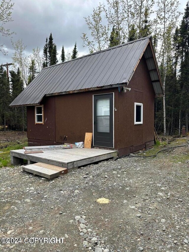 back of house with a wooden deck