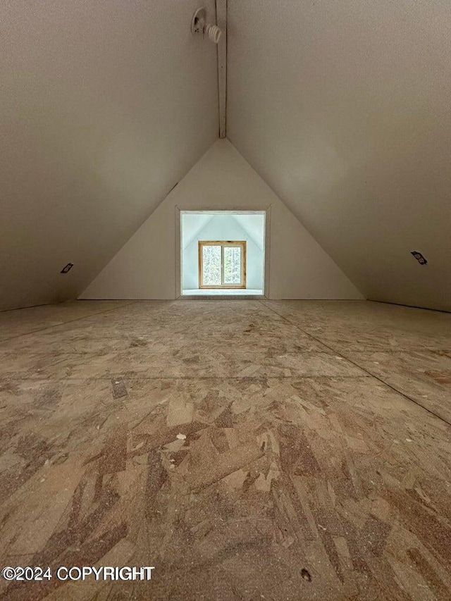 additional living space featuring carpet floors and vaulted ceiling