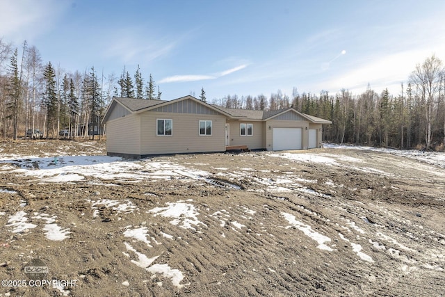 4980 Kelsi Loop, Wasilla, AK 99654 - snow covered property featuring board and batten siding and a garage