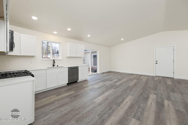 4980 Kelsi Loop, Wasilla, AK 99654 - kitchen with wood finished floors, a sink, vaulted ceiling, light countertops, and dishwasher