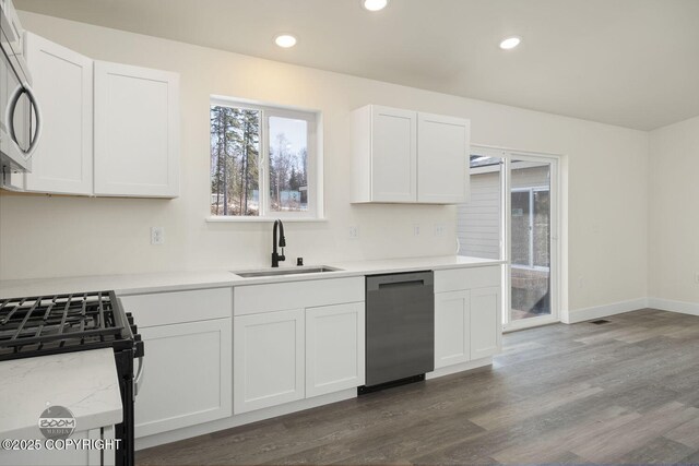 4980 Kelsi Loop, Wasilla, AK 99654 - kitchen with white cabinets, dark wood-style flooring, appliances with stainless steel finishes, and a sink