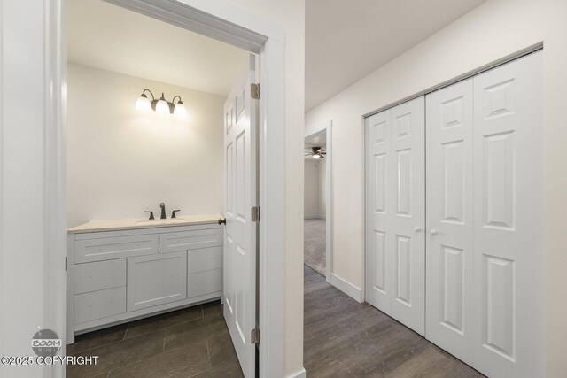 4980 Kelsi Loop, Wasilla, AK 99654 - bathroom featuring a closet, wood finished floors, and vanity