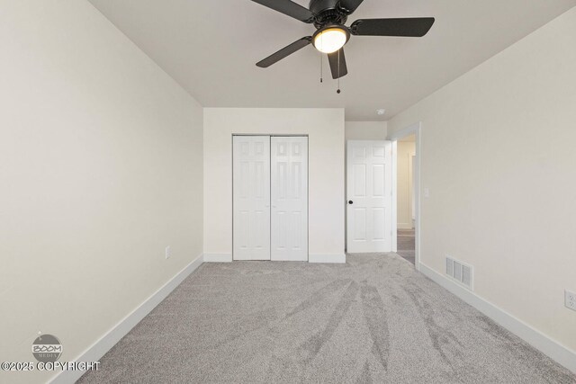 4980 Kelsi Loop, Wasilla, AK 99654 - unfurnished bedroom with visible vents, baseboards, ceiling fan, carpet flooring, and a closet