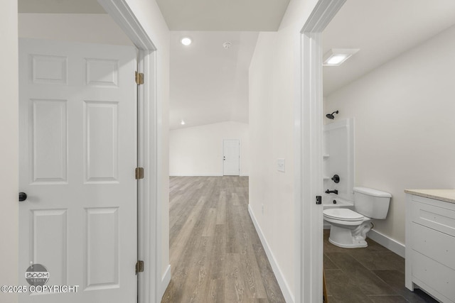 4980 Kelsi Loop, Wasilla, AK 99654 - full bath featuring vanity, wood finished floors, baseboards, shower / bath combination, and toilet