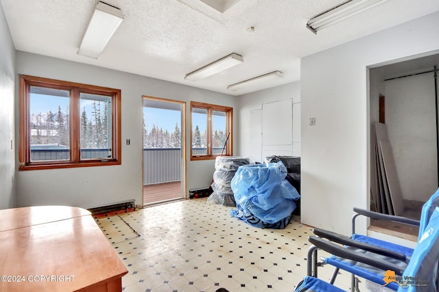 interior space featuring a textured ceiling and a healthy amount of sunlight