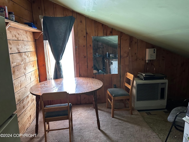 carpeted dining area featuring heating unit, wooden walls, and vaulted ceiling