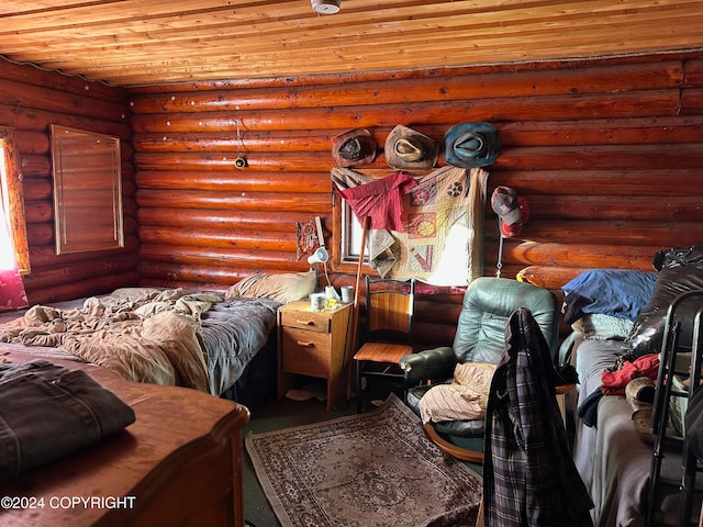 bedroom with log walls and wood ceiling