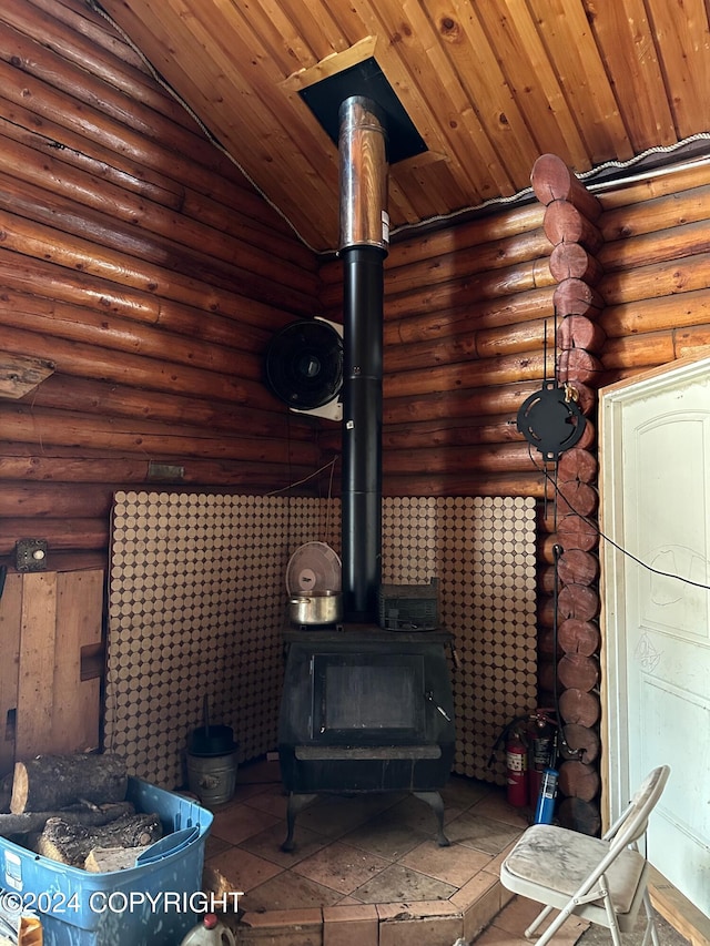 interior details with a wood stove, rustic walls, and wood ceiling