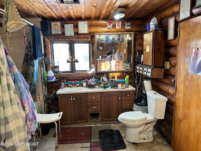 bathroom with vanity, toilet, wood ceiling, and log walls