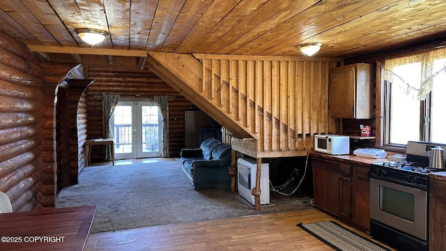 68537 Veater Ave, Ninilchik, AK 99639 - unfurnished living room featuring wooden ceiling, log walls, french doors, heating unit, and wood finished floors