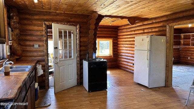 68537 Veater Ave, Ninilchik, AK 99639 - kitchen featuring freestanding refrigerator, a sink, wood ceiling, wood finished floors, and rustic walls