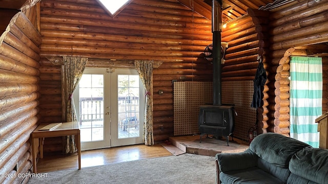 68537 Veater Ave, Ninilchik, AK 99639 - carpeted living area with a wood stove, rustic walls, and french doors