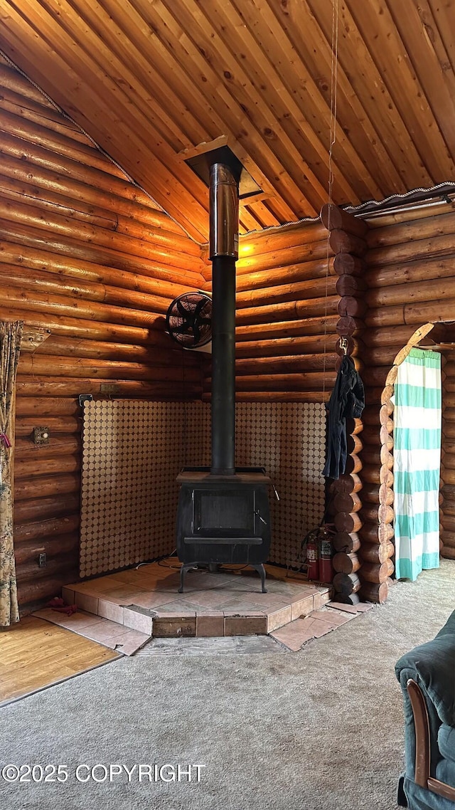 68537 Veater Ave, Ninilchik, AK 99639 - unfurnished living room featuring a wood stove, carpet floors, log walls, and wood ceiling