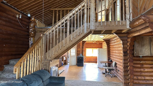 68537 Veater Ave, Ninilchik, AK 99639 - living room featuring wood finished floors, rustic walls, a high ceiling, and stairs