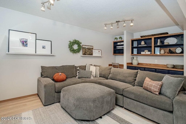 living room with hardwood / wood-style floors and a textured ceiling