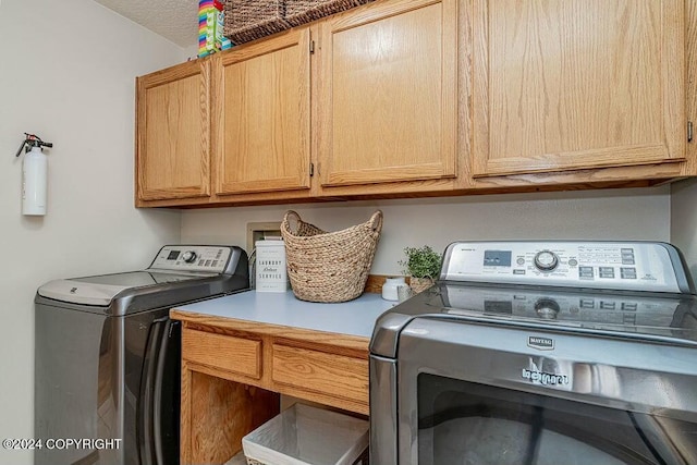 laundry room with cabinets and washer and dryer